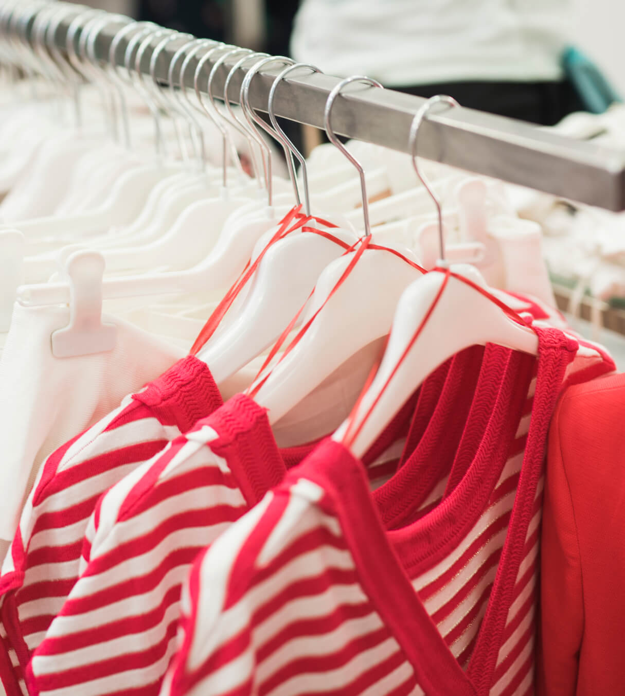 A row of shirts hanging on a clothes rack.